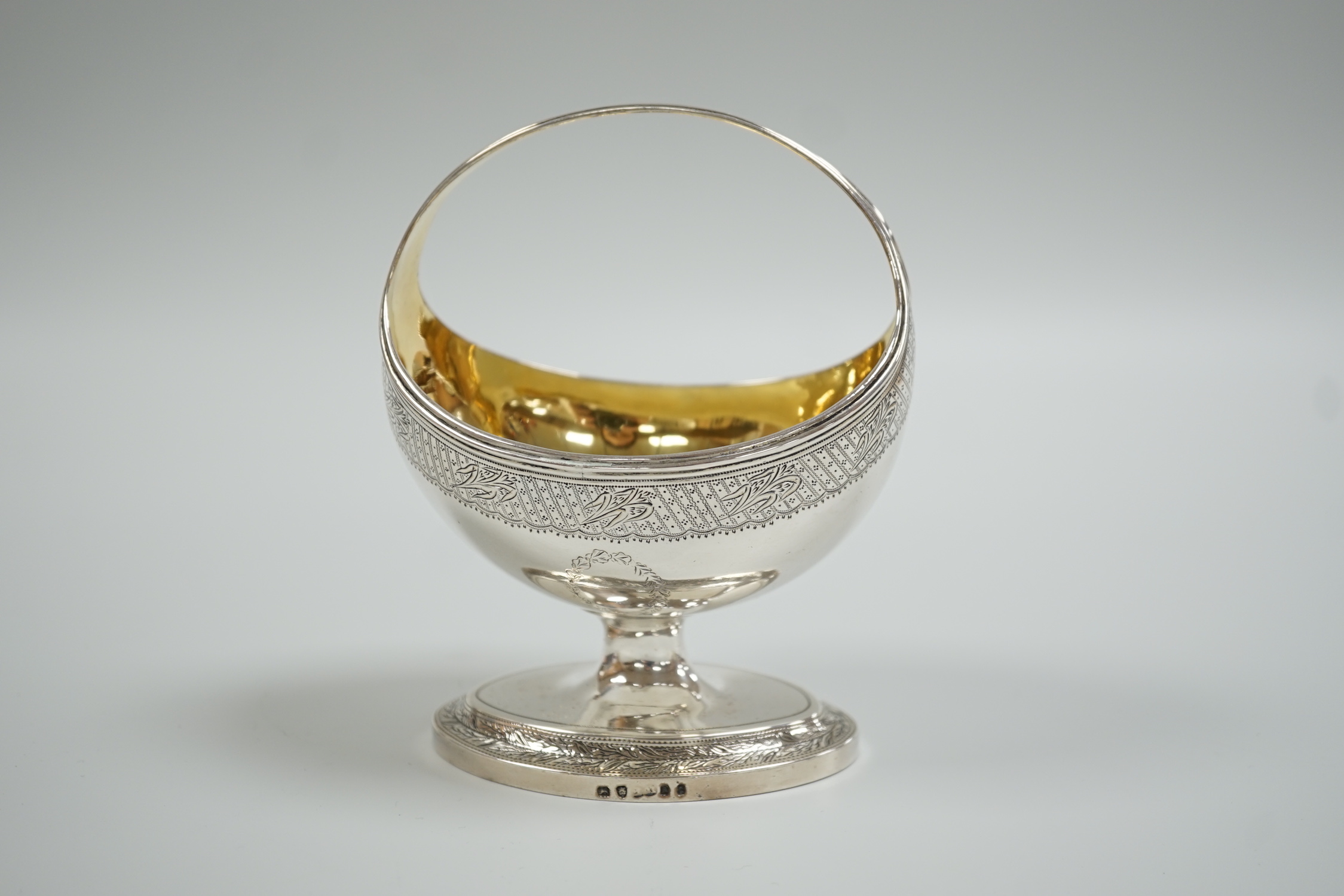 A George III engraved silver boat shaped sugar basket, with fixed handle, William Fountain, London, 1796, height 13cm, 7.2oz.